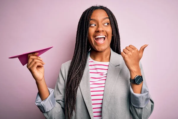 Young African American Business Woman Holding Paper Plane Communication Symbol — Stock Photo, Image