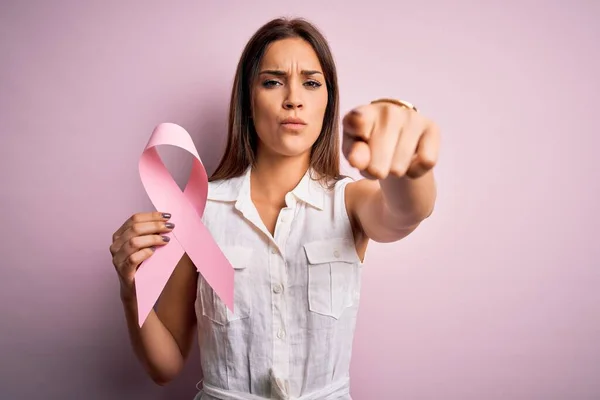 Young Beautiful Brunette Woman Holding Cancer Ribbon Symbol Pink Background — Stock Photo, Image