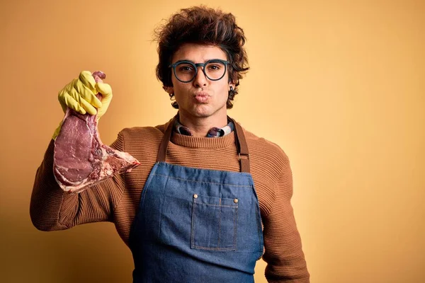 Young Handsome Butcher Man Holding Meet Steak Standing Isolated Yellow — Stock Photo, Image