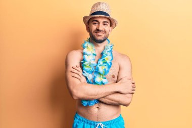 Mayolu, kel, yakışıklı ve mayosuz genç bir adam ve Hawaii 'li mutlu bir yüz, kollarını kavuşturup kameraya bakıyor. pozitif kişi. 