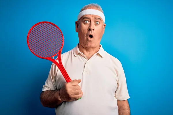 Middle Age Hoary Sportsman Playing Tennis Using Racket Isolated Blue — Stock Photo, Image