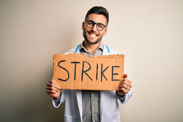 Young Handsome Doctor Man Protesting Holding Cardboard Strike Message Happy — Stock Photo, Image