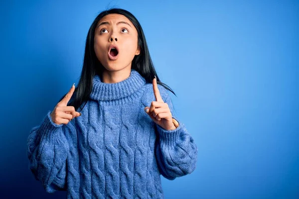 Молодая Красивая Китаянка Обычном Свитере Изолированном Синем Фоне Удивлена Удивлена — стоковое фото