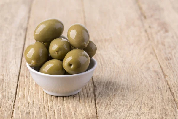 Pickled green olives in a bowl — Stock Photo, Image