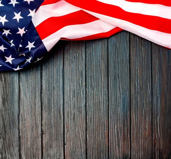 US flag on wooden background.