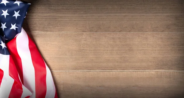 US flag on wooden background. N