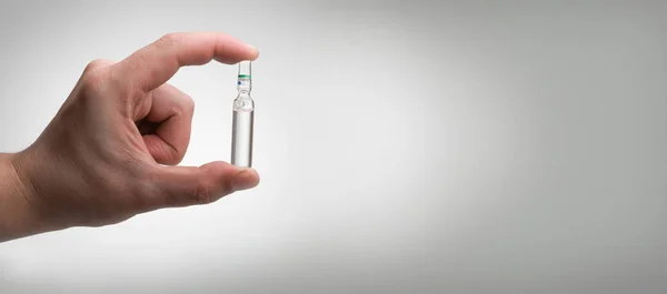 Ampoule in a hand — Stock Photo, Image