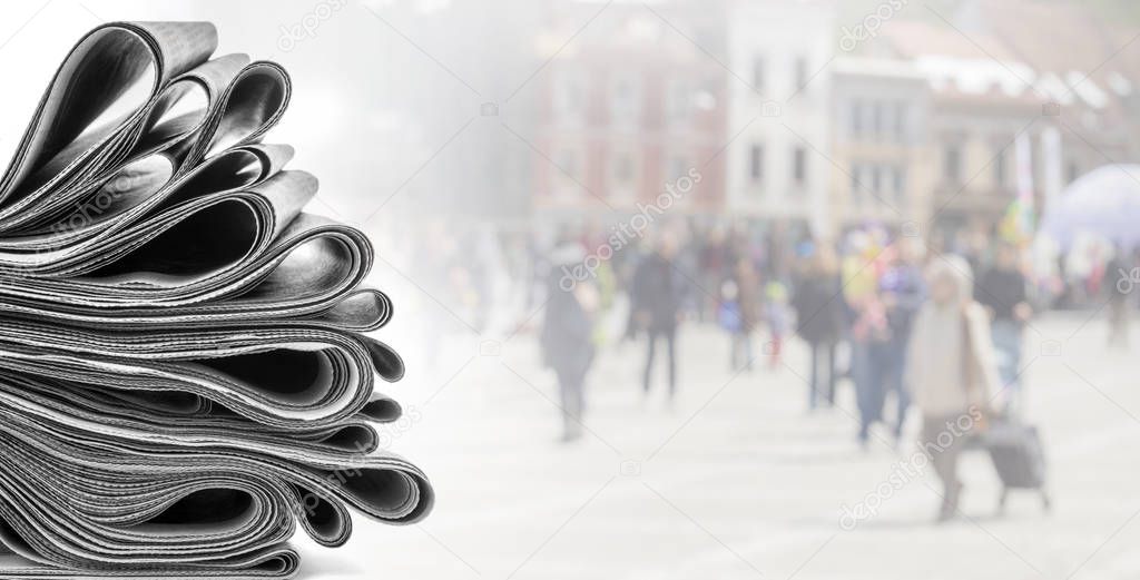 Pile of newspapers on white 