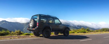 Madeira, Portugal - December 21. 2019: tourists on a jeep inspect the mountain pass on Madeira island, Portugal