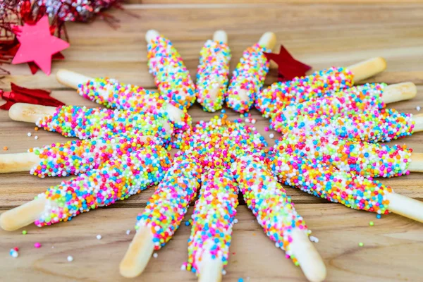 Biscuit stick with coloured sprinkles — Stock Photo, Image