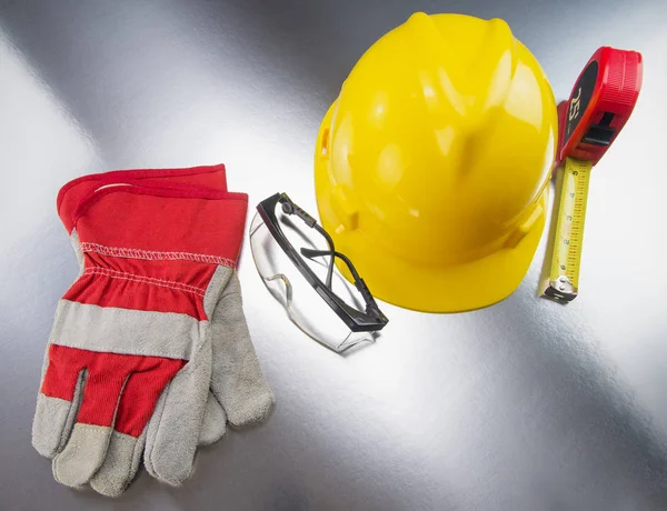 Construction Gear on Silver Tabletop with Hardhat — Stock Photo, Image