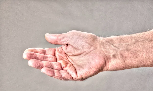 Homeless hand reaching out for spare change — Stock Photo, Image