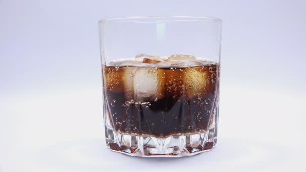 Glass of Soda Drink with Ice Cubes and Bubbles. — Stock Video