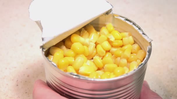 Man Eating the Corn Kernels from a Metal Jar — Stock Video