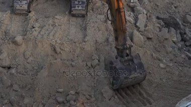 Ekskavatör inşaatta çalışan yakın çekim görünümü.