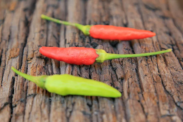 Hot chili pepper on old wooden — Stock Photo, Image