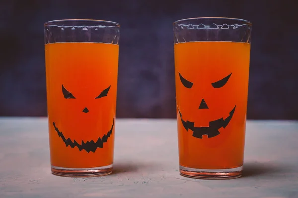 glasses with spooky pumpkins and cookies for Halloween