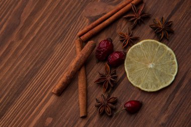 Limon ve baharat ahşap bir masa üzerinde. Baharat narenciye karanlık bir arka plan üzerinde üzerinde.