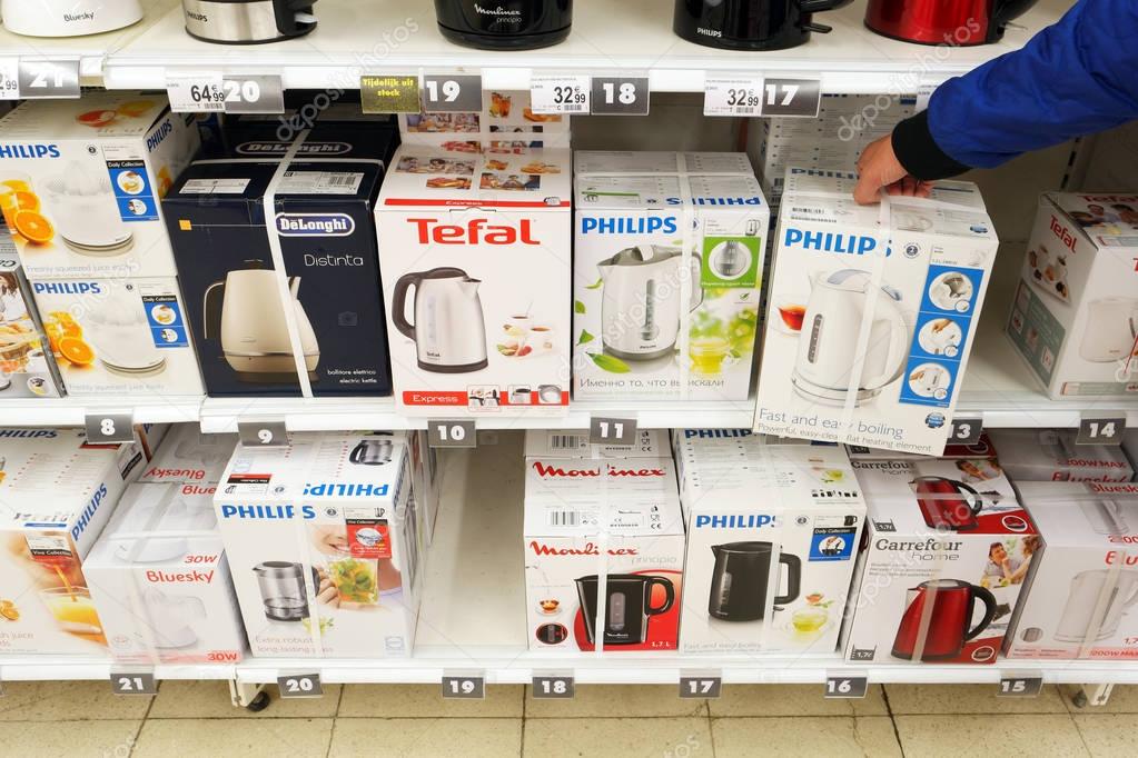 BELGIUM, OCTOBER 2016: Different brands electric water boilers on an aisle with home appliances in a Carrefour Hypermarket.