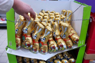 GERMANY - JANUARY 2018: A box with crammed chocolate Easter Bunnies in a german discount Supermarket. clipart