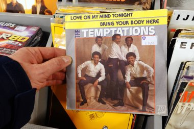 THE NETHERLANDS - NOVEMBER 2019: Single: The Temptations - Love On My Mind Tonight. Single record of the American vocal group The Temptations in a second hand store. clipart