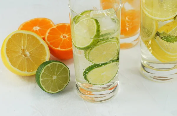 Agua mineral de desintoxicación con cal, mandarina y limón sobre un fondo claro — Foto de Stock
