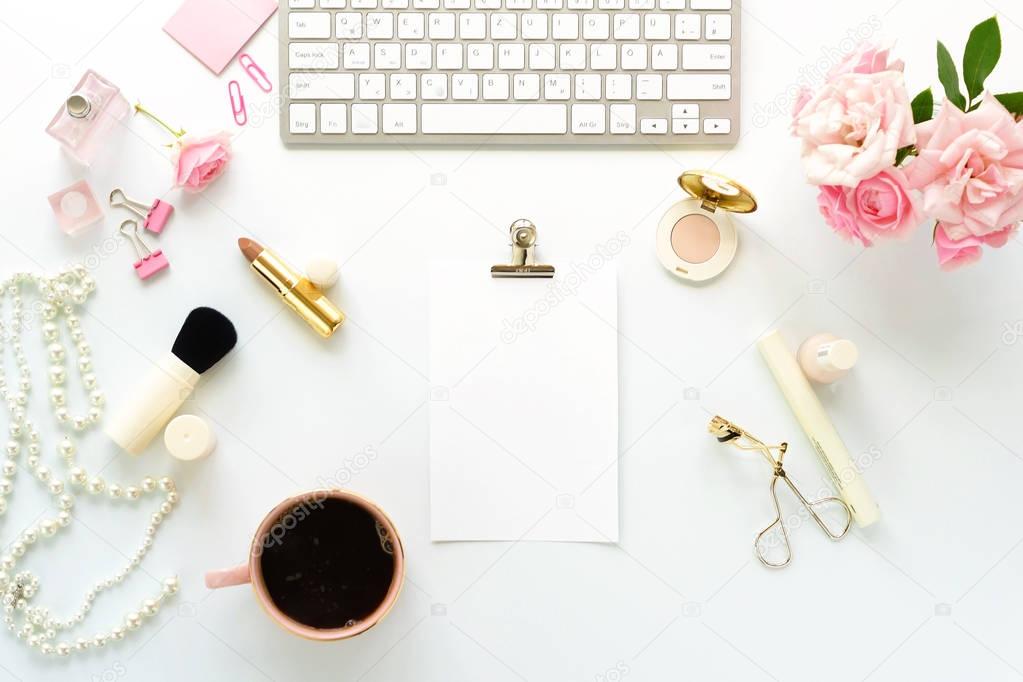 Beauty blog concept. Female make up accessories, cup of cofee and bouquet of pink roses on white background. Flat lay, top view feminine desk, workspace with laptop. Copy space