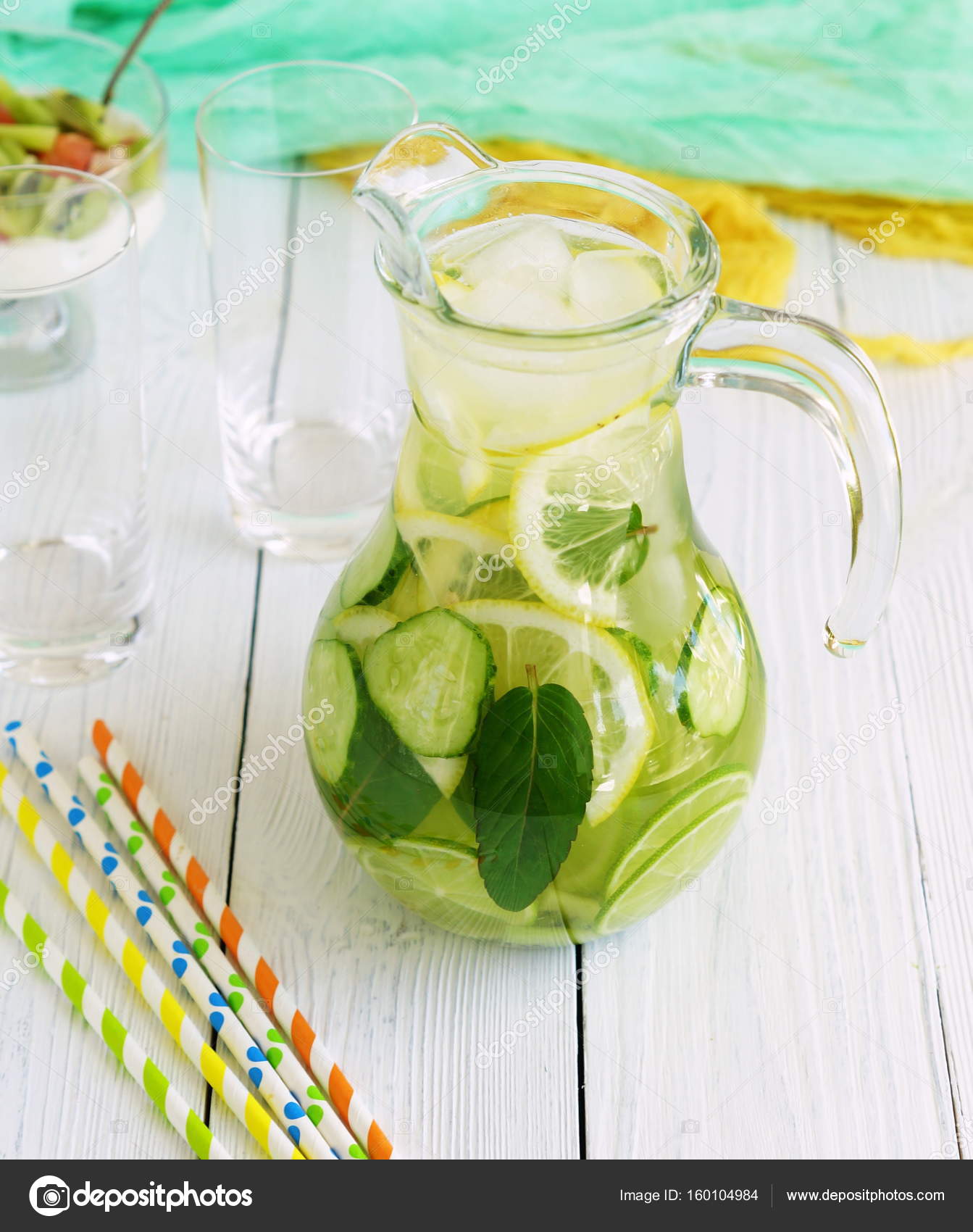 Detox water with cucumber, lemon, lime and mint in a jug on a