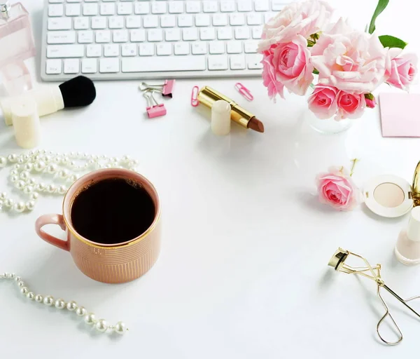 Flat lay, top view office feminine desk, female make up accessories, workspace with laptop, cup of coffee and bouquet roses.Beauty blog concept — Stok Foto