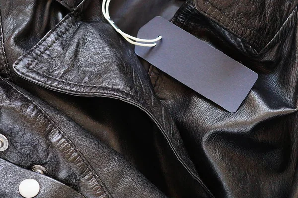 Blank mock-up label tag on leather jacket.