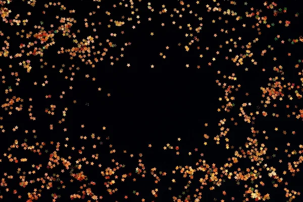 Siyah bir zemin üzerine altın glitter — Stok fotoğraf