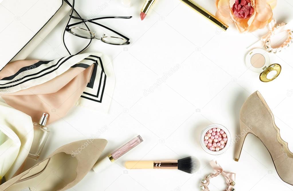 Female fashionable stylish accessories and make up cosmetics. Beige shoes with heels, bag, headscarf, glasses, lipstick, mascara, powder, brush, parfume on a white background. Copy space.Flat lay.top