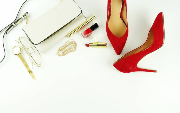 Female fashionable stylish accessories and cosmetics. red shoes with heels, white bag, perfume, glasses, lipstick, red nail polish on a white background. Beauty blog concept. Top view. Flat lay
