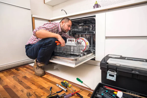 Handyman repair dishwasher in  the kitchen