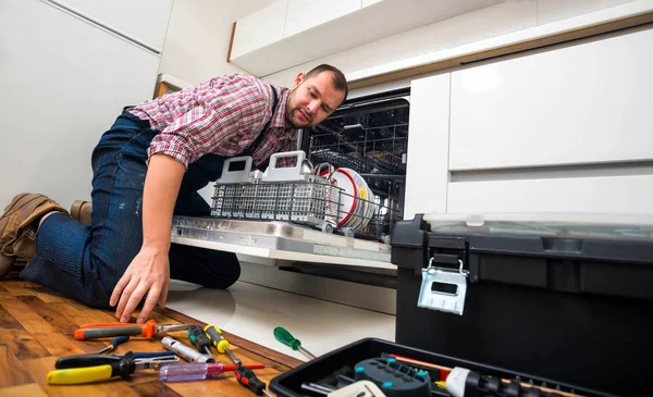 Handyman repair dishwasher in  the kitchen