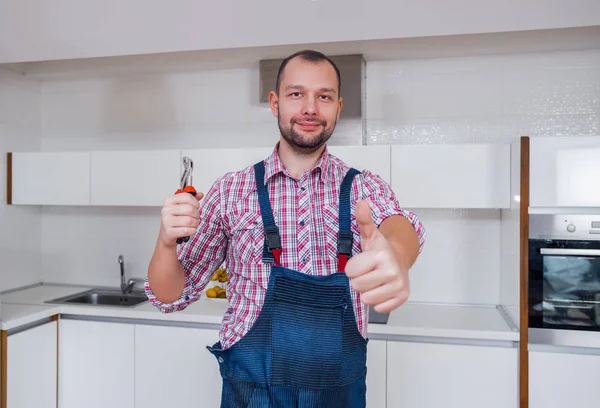 Workman Uniform Holding Pliers Kitchen — Stock Photo, Image