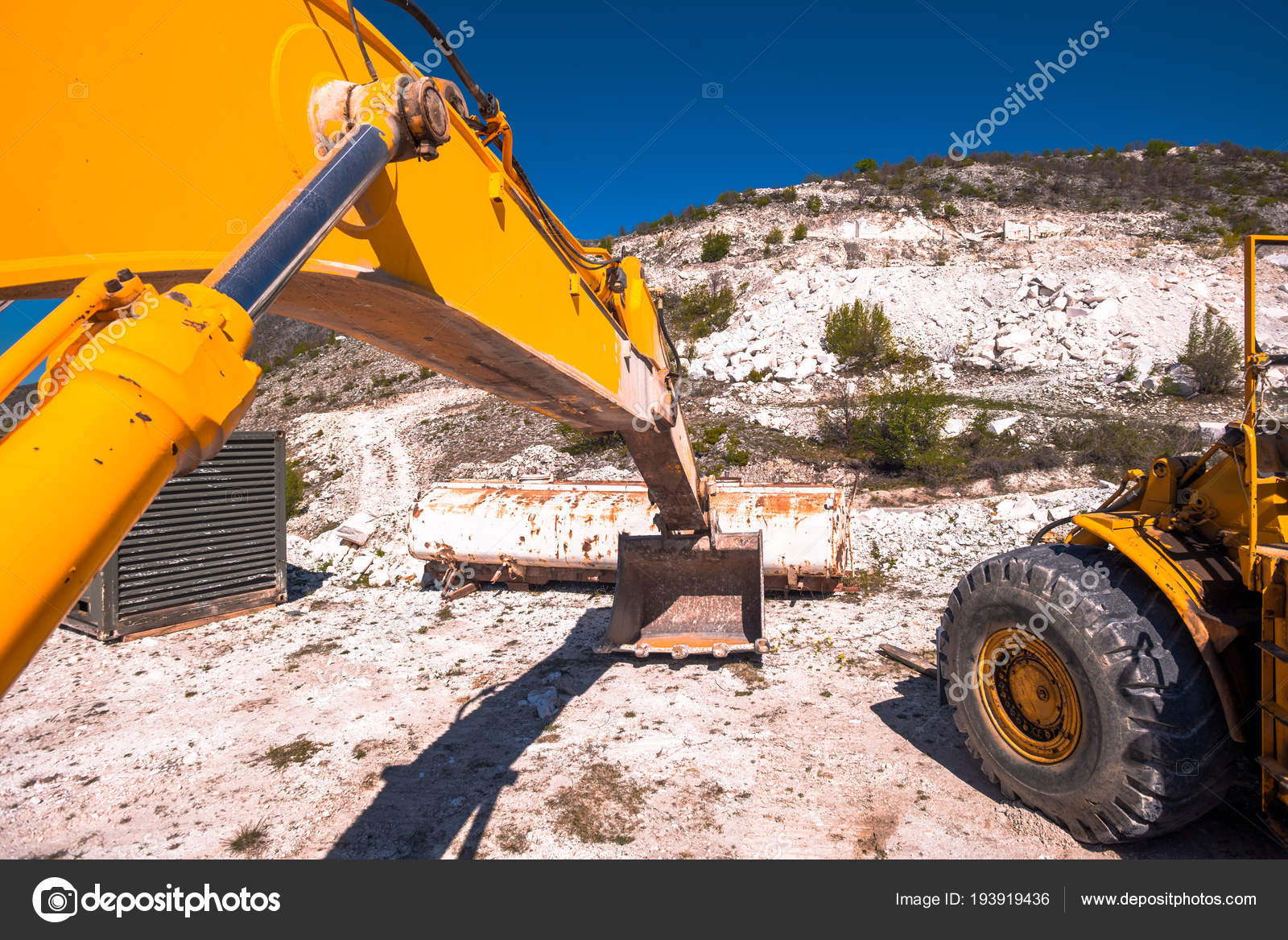 Yellow Excavator Digging Mountain Stock Photo by 193919436