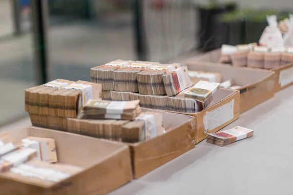 Large sum of money placed in boxes at the center of cash service — ストック写真
