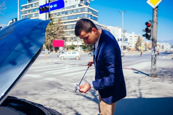 Um homem de negócios bonito vestindo blazer azul levantando o capô o — Fotografia de Stock