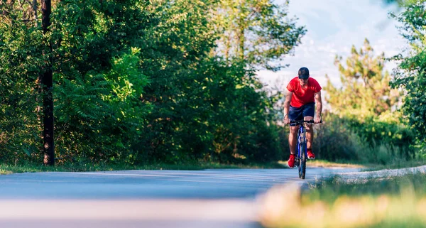 自転車に乗る(自転車)自然の中で空の道路に乗るフィット — ストック写真
