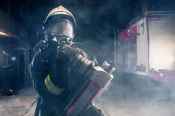 Portrait of a female firefighter wearing a helmet and all safety