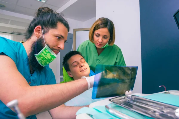 Mężczyzna Kobieta Dentyści Pokazując Młody Chłopiec Pacjent Jego Zęby Rentgenowskie — Zdjęcie stockowe