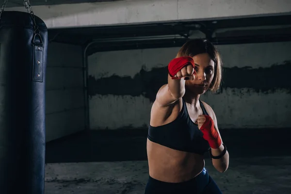 Young Beautiful Female Preparing Her Bandages Kicking Boxing Bag — Stock Photo, Image