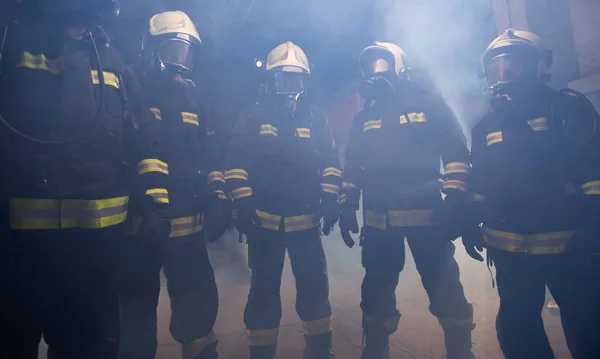 Portrait of group of firefighters in the middle of the smoke of — Stock Photo, Image