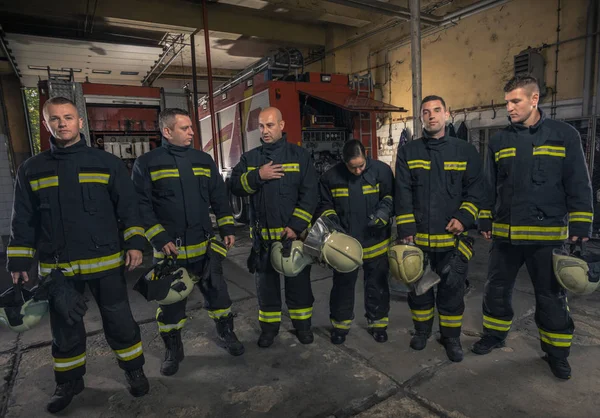 Portrait of firefighters standing by a fire engine. — Stock Photo, Image