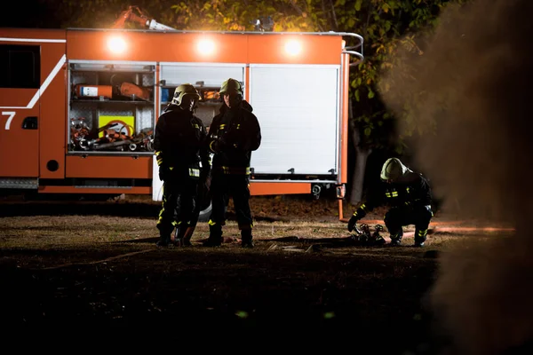 Fire brigade in action at night time — Stock Photo, Image