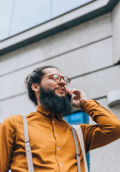 Elegante Hipster Com Uma Longa Barba Durante Uma Conversa Telefônica — Fotografia de Stock