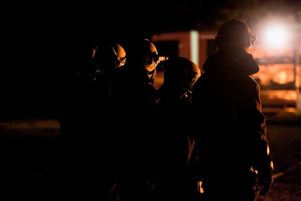 stock image Fire brigade during operation in the field at night time