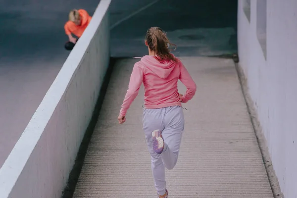 Attractive fit woman performing an outdoor running exercise