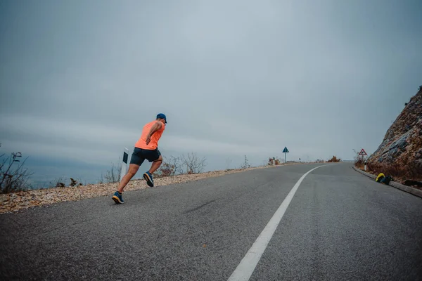 Well built mature runner dressed in fitness wear going for a run